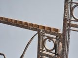 a sculpture of a cross made out of wood and metal