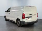 the back of a white van is parked in a large room