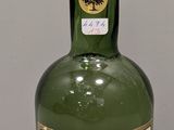 a bottle of liquor sitting on a table next to a bottle of liquor
