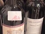 many bottles of wine sitting on a shelf in a store