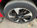 the tire of a red car with a black rim is shown