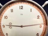 a clock that is sitting on a stand on a table