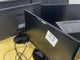 two computer monitors sitting on a desk next to each other