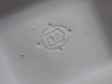 a small white plate with a chinese symbol on it