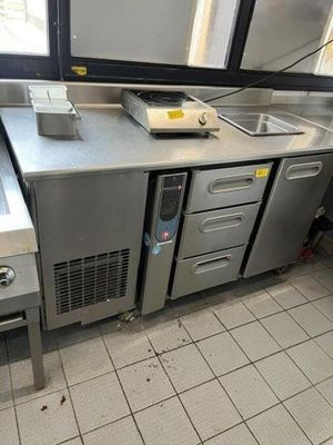 a kitchen with stainless steel counter tops and a sink