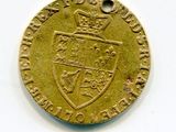 an old gold coin with a crown on top of it