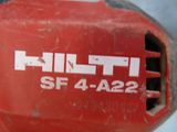 a close up of a red drill with a white logo on it