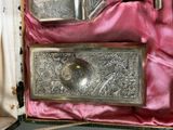 a silver box with a silver spoon and a silver spoon in it