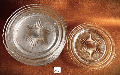 two glass dishes sitting on a brown table cloth