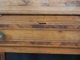 a wooden chest with a drawer on top of it