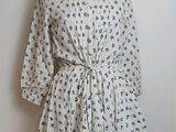 a dress on a mannequin stand on a white wall