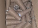 a box full of toilet paper rolls sitting on the floor