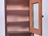 a small wooden cabinet with a mirror in it