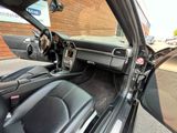 the interior of a car with the door open and the steering wheel down