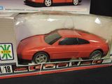 a red toy car in the box on the table