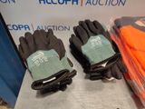 two pairs of gloves sitting next to each other on a table