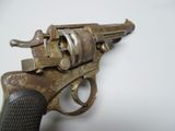 an old gun on a white surface with a white background