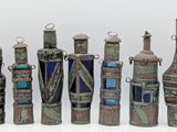 many bottles that are lined up together on a white surface