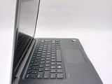 a laptop that is open on a white surface