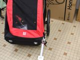 a stroller with a dog in it on the floor