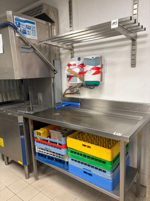a stainless steel work table with a bunch of plastic containers on it