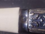a close up of a silver and white object on a table