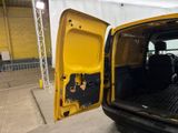 a yellow van with the door open in a building