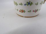 a white cup with a floral design on it