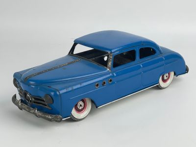 a blue toy car that is sitting on a white surface