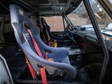 two seats in the back of a car with a red seat belt