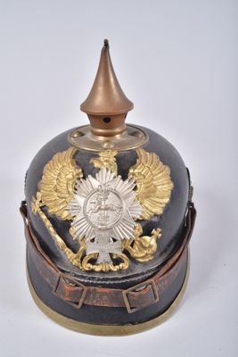 a black and gold helmet with a gold crown on it