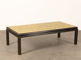 an image of a coffee table with a wooden top on a concrete floor