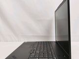 the back of a laptop computer sitting on top of a white table