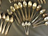 a lot of silver spoons and spoon spoons on a table