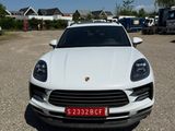 the white porsche cayen is parked in the parking lot