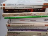 many books stacked on top of each other on a table