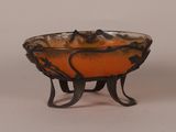 an orange bowl with a bird design on it
