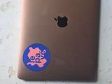 a laptop with a sticker on it sitting on a table