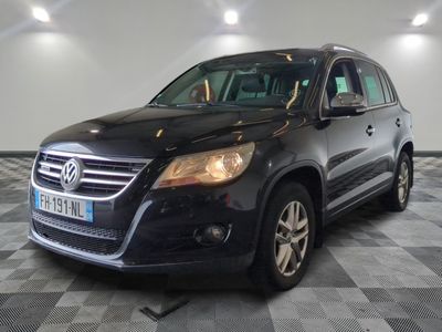 the black volkswagen suv is parked on a checkered tile floor