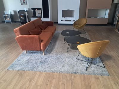 a living room with a couch, chair, coffee table and fireplace