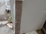 a piece of cardboard taped to the side of a refrigerator