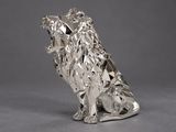 an image of a silver sculpture of a dog sitting on its hind legs