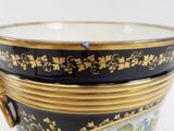 a black and gold vase with flowers on it