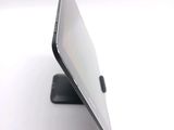 a close up of a laptop on a stand on a white surface