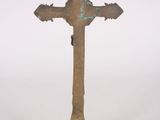 bronze cross on a pedestal on a white background