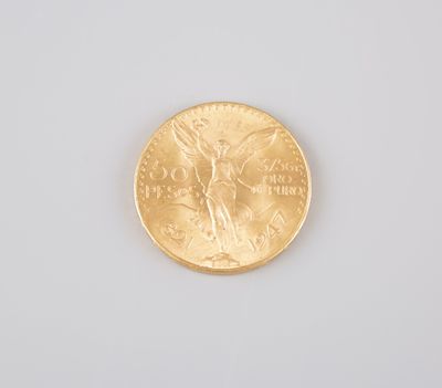 a close up of a gold coin on a white surface