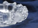 a close up of a clear glass bowl on a blue cloth