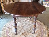 a table with a wooden top on a rug in a room