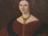 tableau représentant une femme en robe rouge tenant une croix