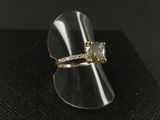 a close up of a ring with a diamond on top of a black surface